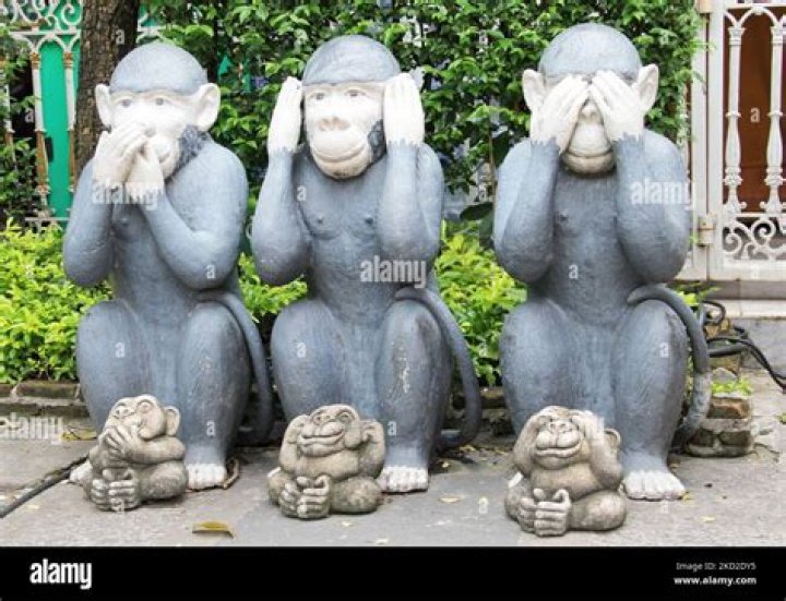What did the three monkey statue mean to Gandhi?