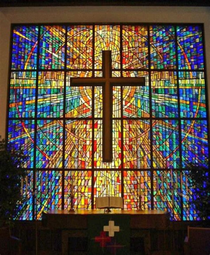 What is the meaning of stained glass windows in churches